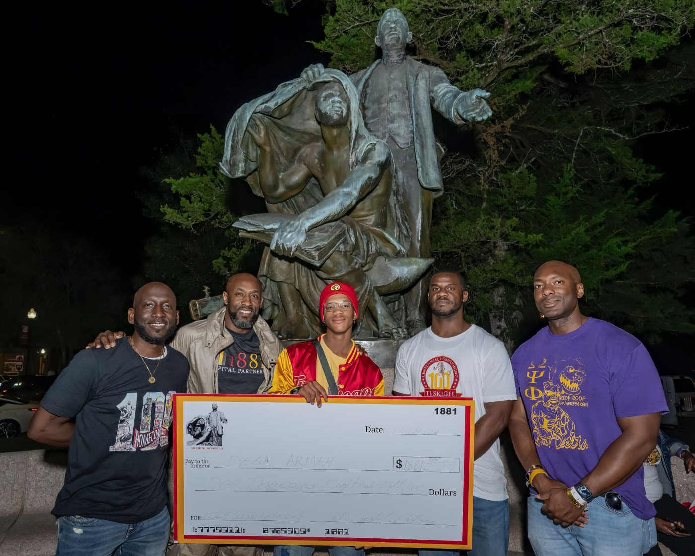 Partners of 1881 Capital Partners presenting the 2024 scholarship to Dela Armah at the Booker T. Washington monument at Tuskegee University